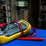 A multimeter on a repair bench.